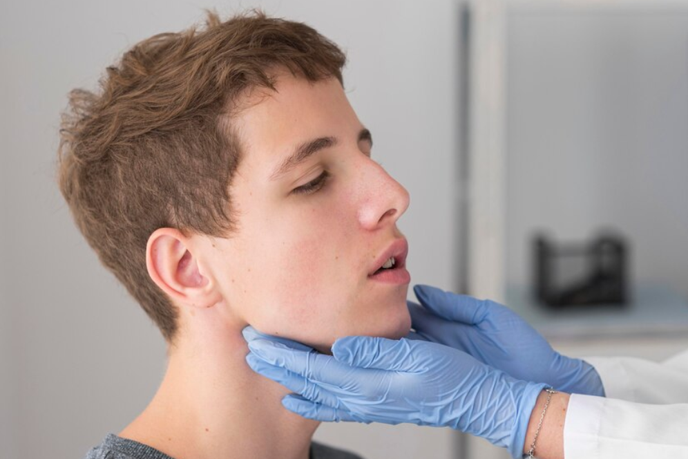male pediatrician doing vaccination to baby boy with a syringe in the hospital